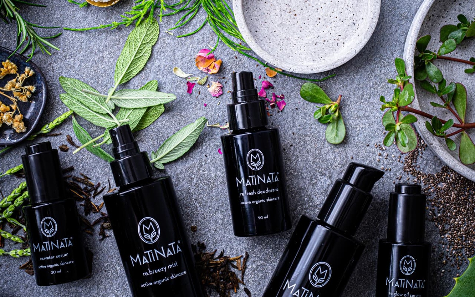 Flat lay of fresh botanicals, aloe, herbs and chia seeds used in Matinata formulas